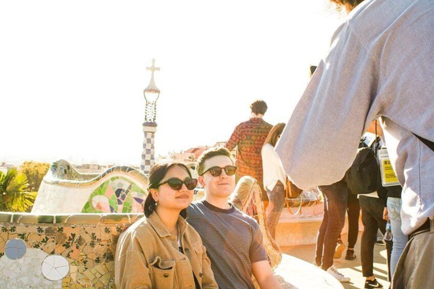 A group of people at a historical site with a tiled wall and a tower in the background. 5