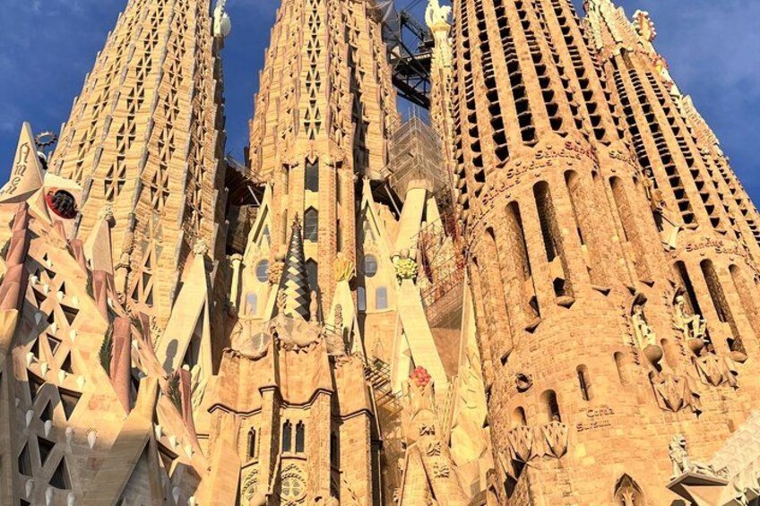 The intricate facade of a large, ornate building with multiple spires and decorative elements. 2