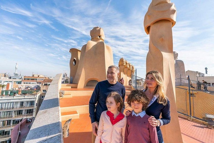 A family on a rooftop with a cityscape in the background. 4