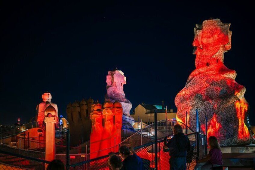 Illuminated sculptures of a man and a woman at night. 5