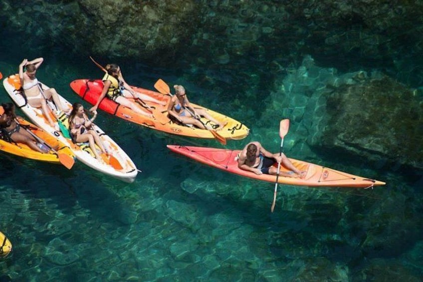 People kayaking on clear water. 1