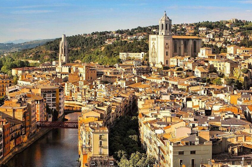 A densely packed urban landscape with a prominent church and a tall bell tower. 5