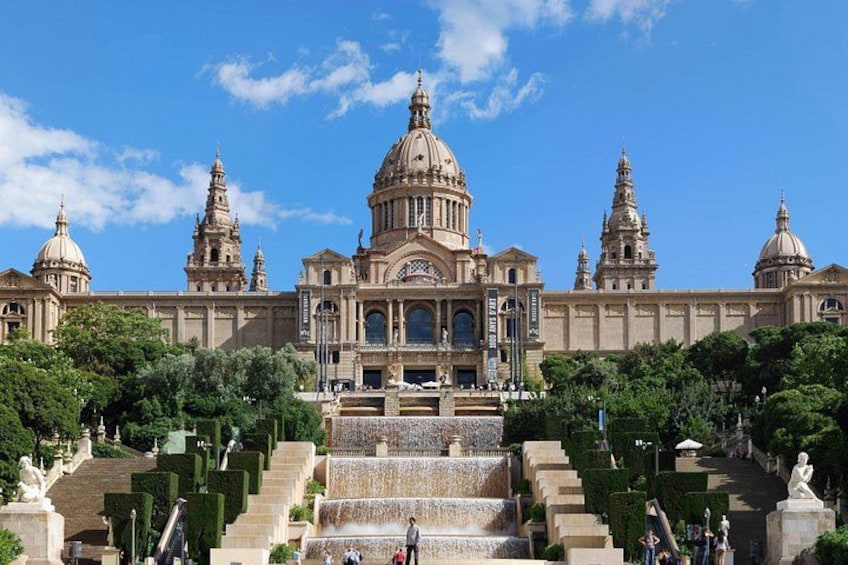 A grand building with a large dome and multiple towers, surrounded by well-manicured gardens and a series of steps leading up to it. 4
