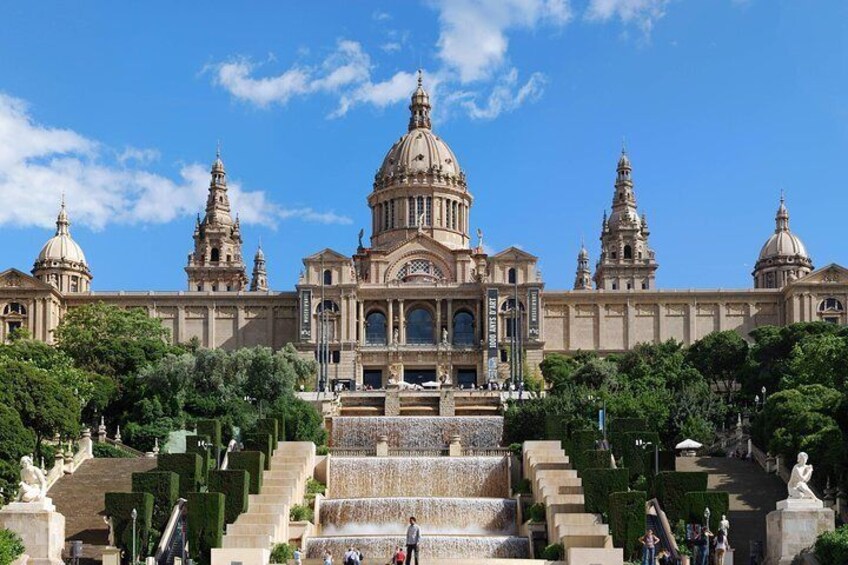 A grand building with a large dome and multiple smaller domes, surrounded by well-manicured gardens and a series of steps leading up to it. 4
