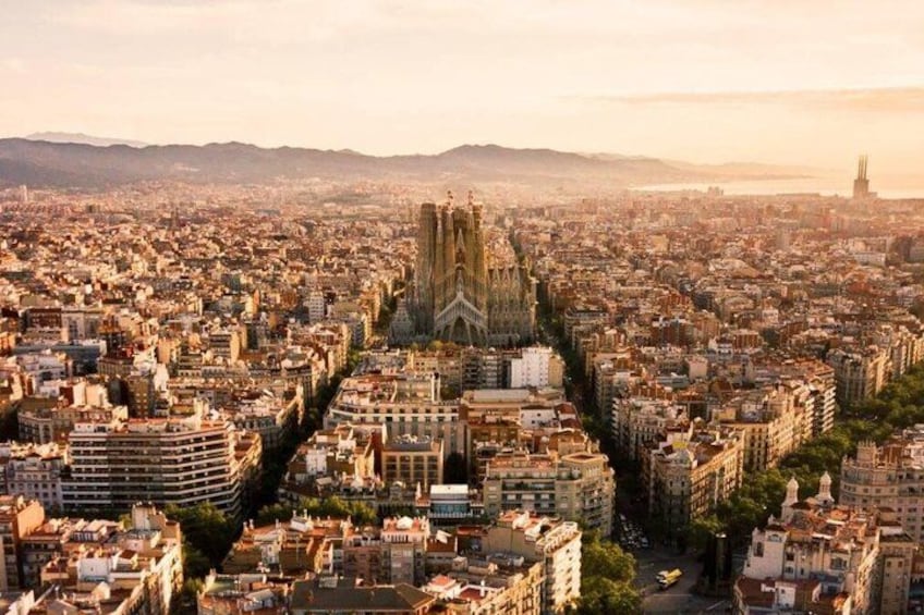 A cityscape with a prominent cathedral and a river in the background. 1