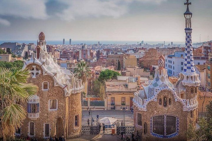 A view of a cityscape with distinctive buildings featuring unique architectural styles, including a building with a checkered pattern and another with a pointed roof. 5