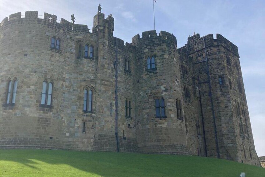 A large stone castle with multiple towers and arched windows. 4