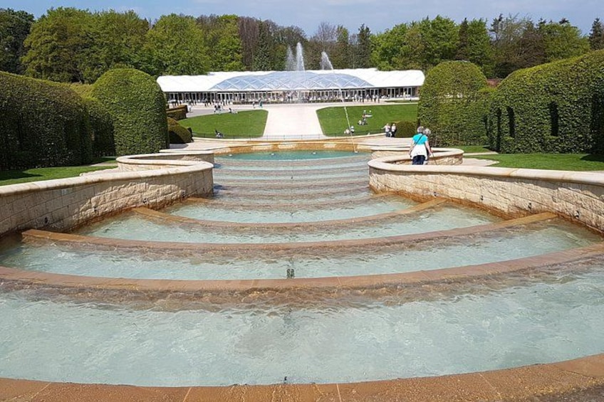 A large outdoor pool with tiered steps leading to a fountain. 4