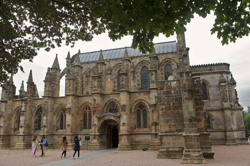 A historic stone building with pointed arches and a large entrance. 3