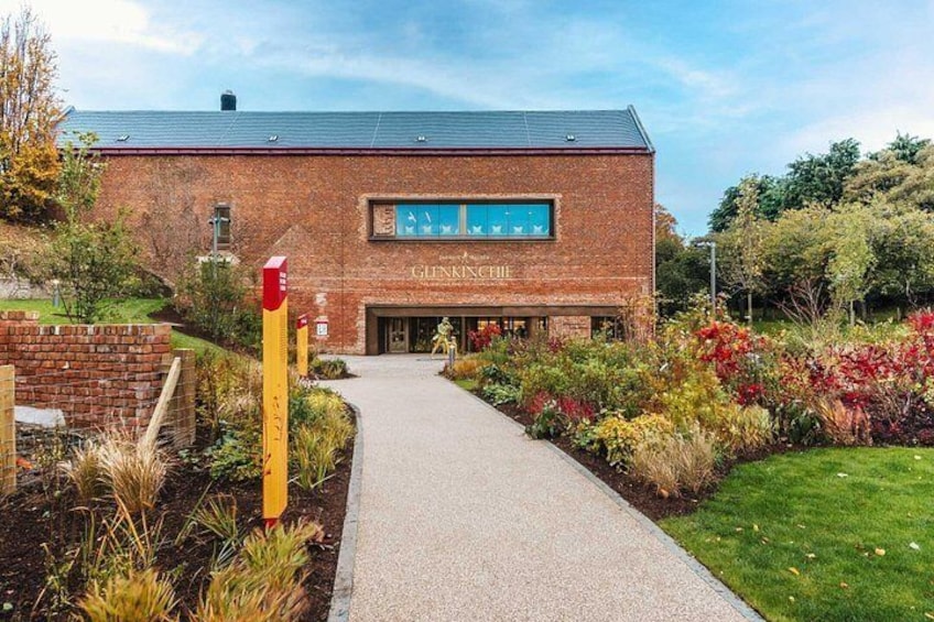 A brick building labeled 'Glennsickle' with a pathway leading to it, surrounded by landscaped gardens and trees. 4