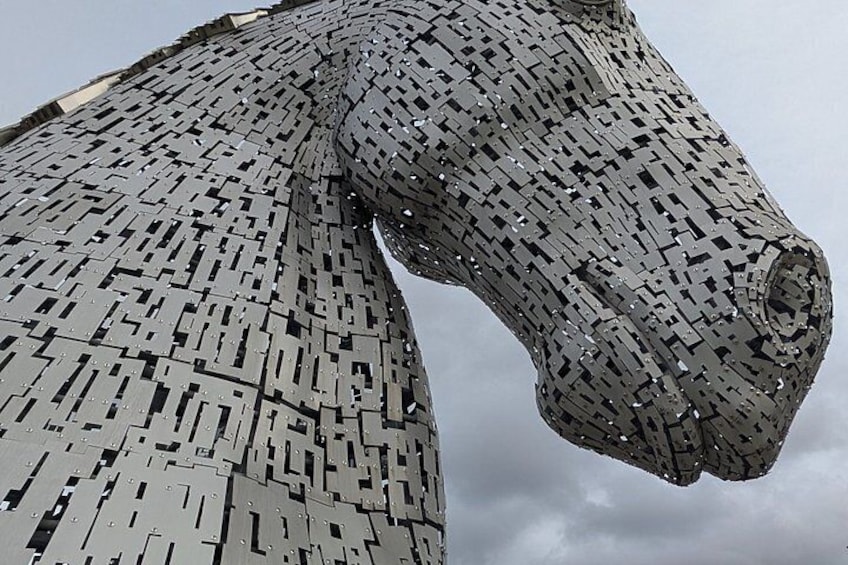 A large, intricate sculpture made of interlocking metal pieces. 5