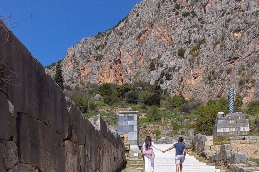 Un paisaje rocoso con una escalera que conduce a un edificio, rodeado de montañas. 4