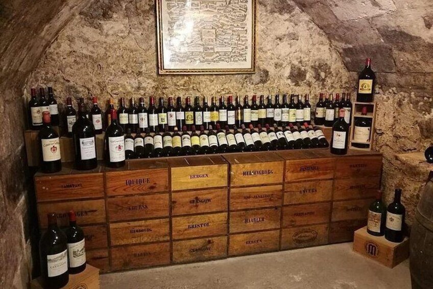 A wine cellar with wooden crates and bottles of wine. 2