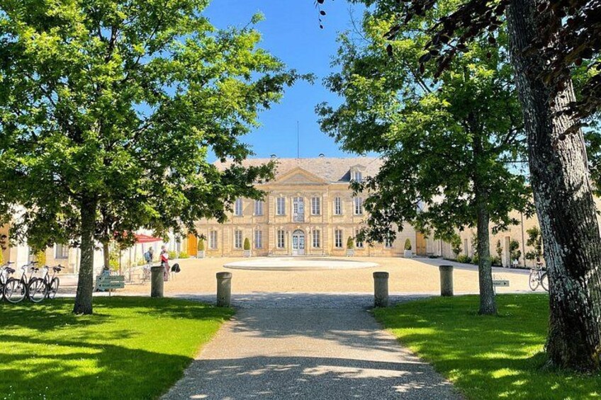 A courtyard with a building, trees, and a pathway. 2