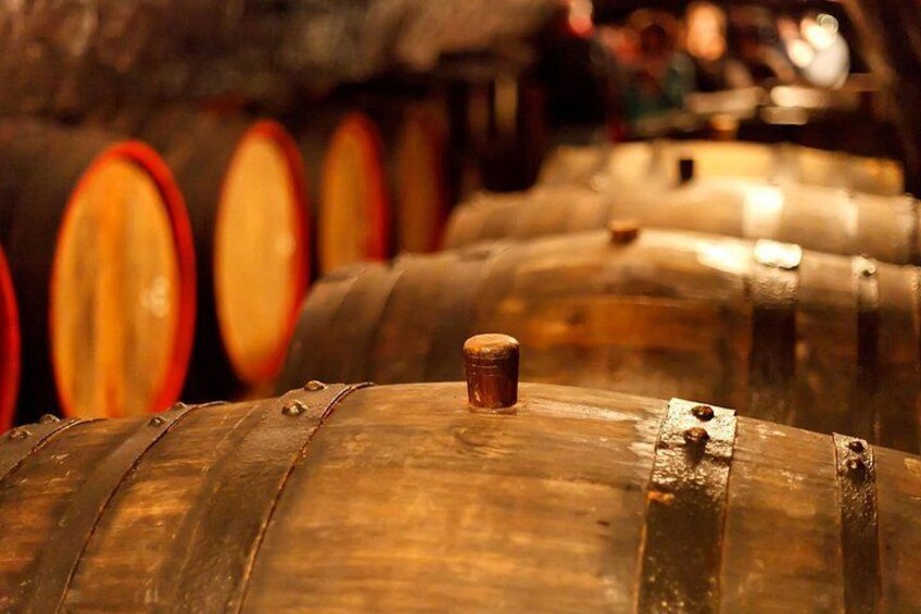 Wooden barrels with metal hoops, likely used for aging wine or spirits. 5