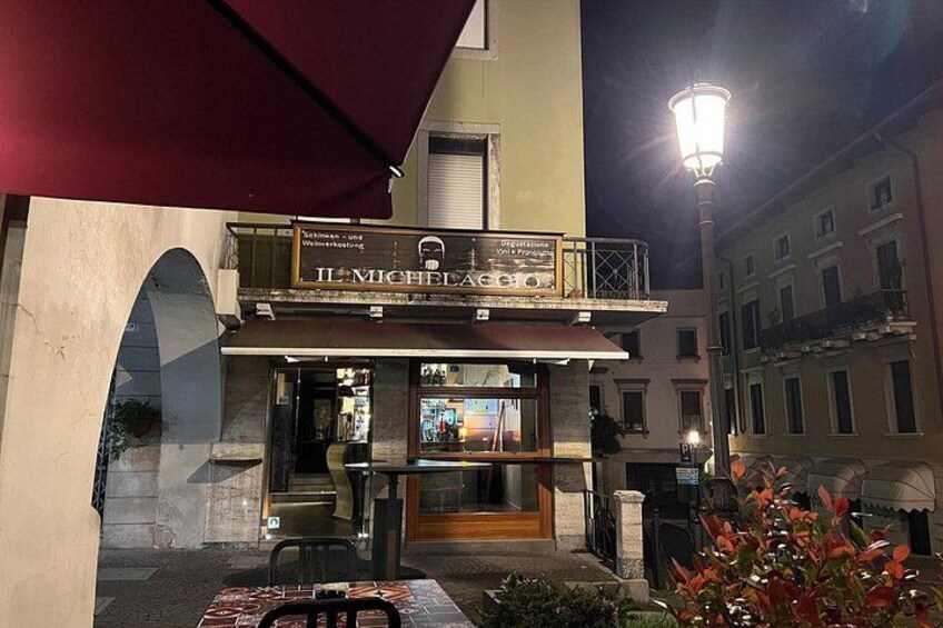 A restaurant named 'Il Michelangelo' with outdoor seating and a red awning. 5