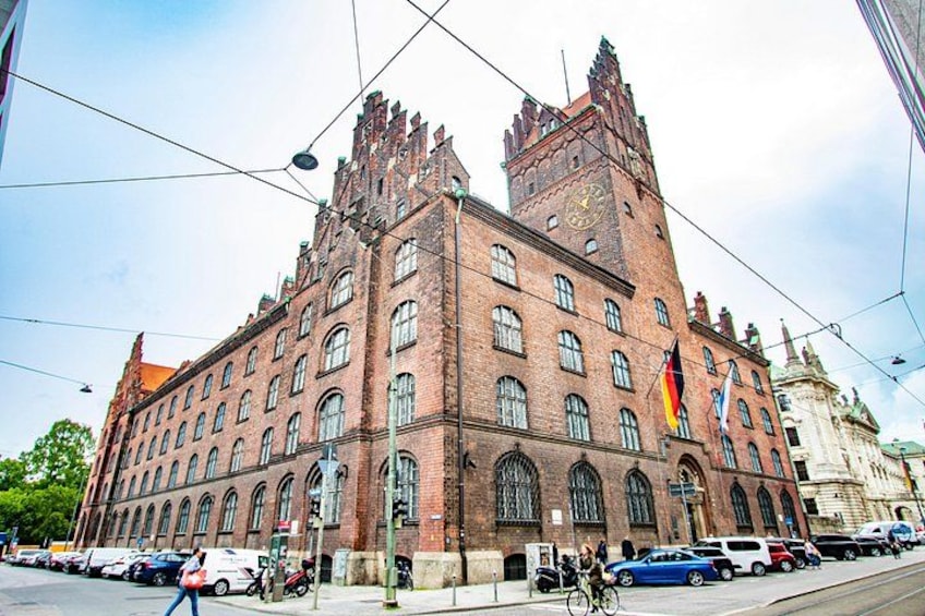 A large brick building with arched windows and a clock tower. 3