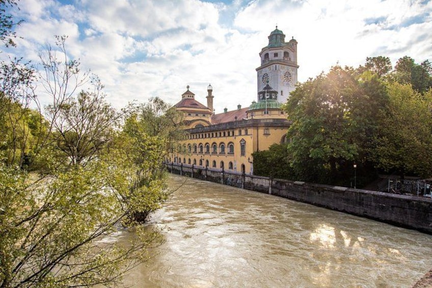 A river with a bridge, a clock tower, and a building with a dome. 5