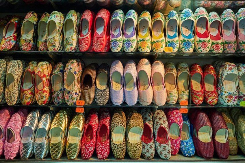 A variety of colorful, patterned shoes displayed on shelves. 4