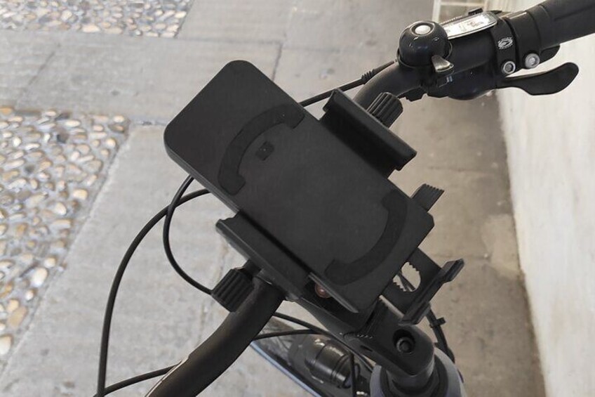 A bicycle with a black box mounted on the handlebars. 4