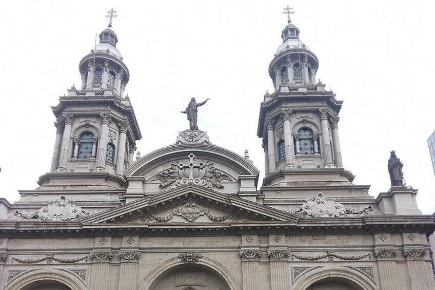 Una iglesia con dos torres, una cúpula central y estatuas en la parte superior. 5