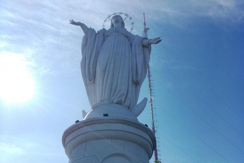 Una estatua con los brazos extendidos, un halo y una cruz en la cabeza, sobre un cielo despejado. 3