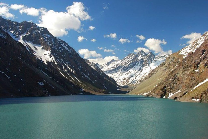 A mountain lake with snow-capped peaks and clear blue water. 5
