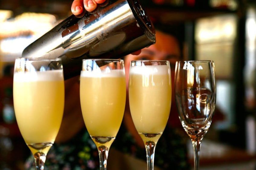 A person pouring a drink into a glass. 3