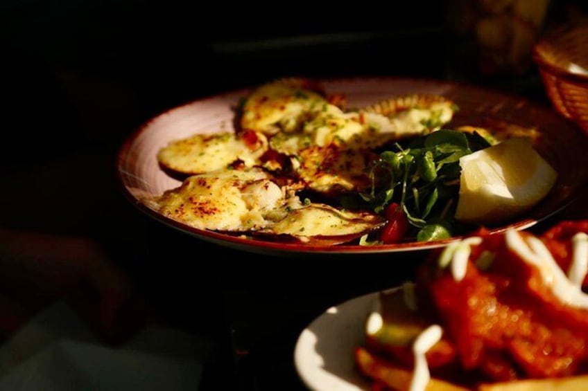 A plate of food with a piece of fish and greens. 3