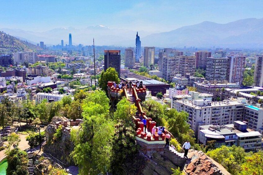 A cityscape with a prominent skyscraper, a suspension bridge, and lush greenery. 4