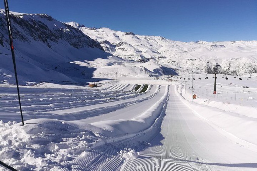 A snow-covered mountain road with a clear sky. 4
