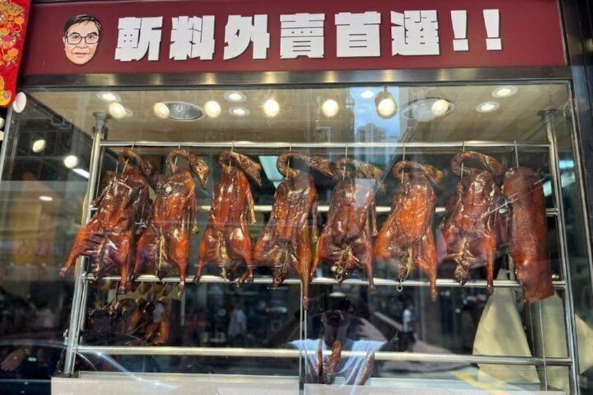 A glass display case with roasted ducks. 2