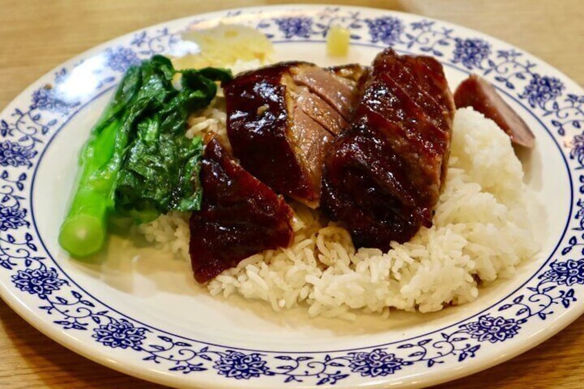 A plate of food with rice, sliced meat, and greens. 3