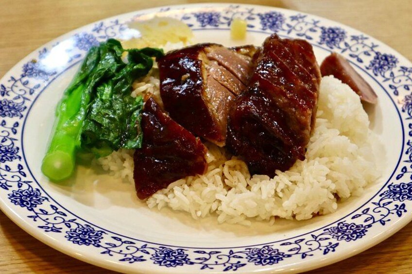 A plate of food with rice, sliced meat, and green vegetables. 2