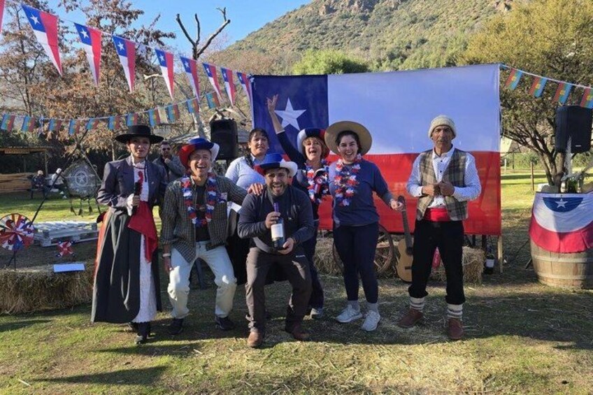 A group of people in historical costumes posing in front of a Texas flag. 3