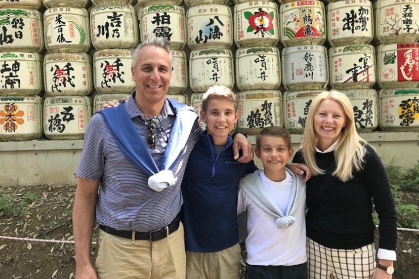 A group of people standing in front of a wall of labeled containers. 4
