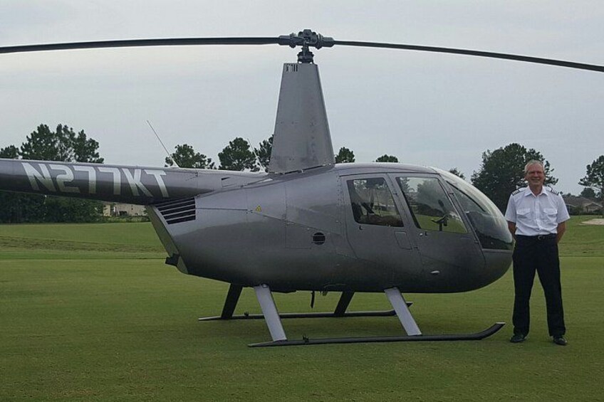 A helicopter with registration N277XT on a grassy field. 4