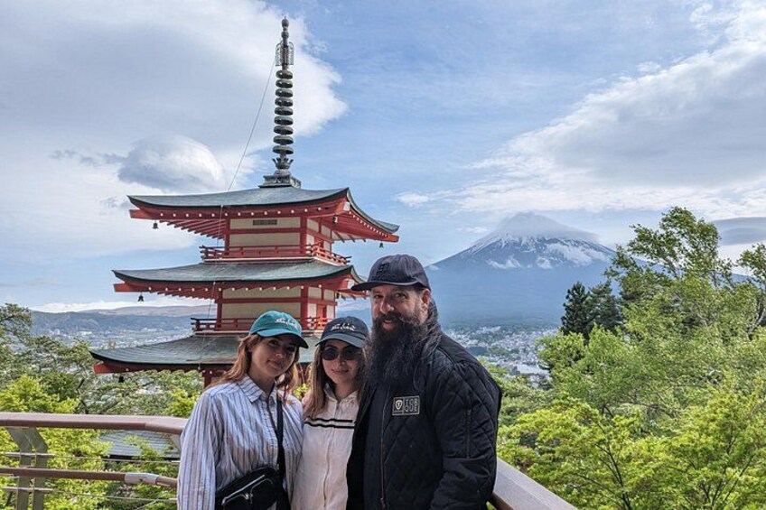 A pagoda, a mountain, and lush greenery. 1