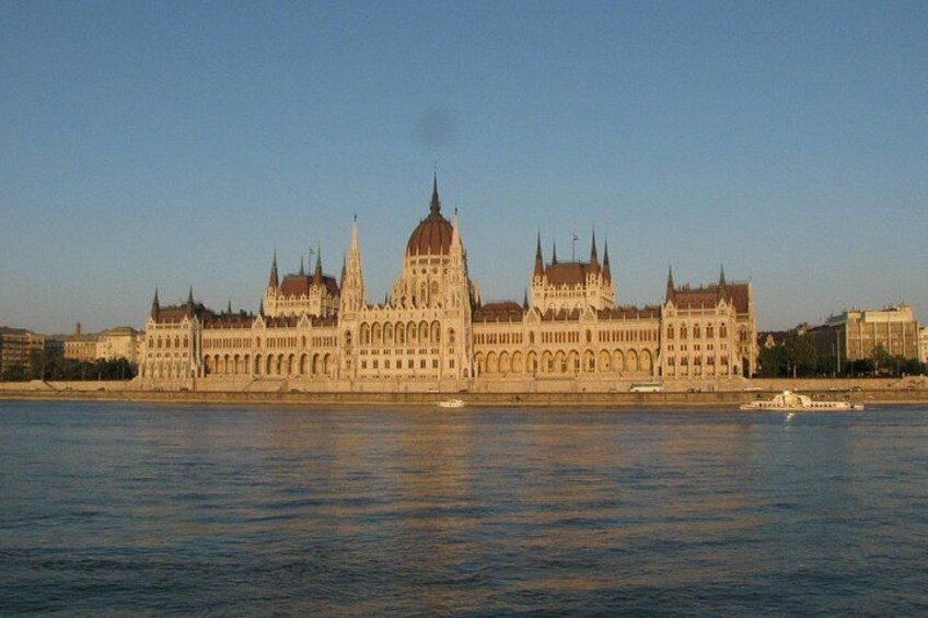 A large, historic building with multiple spires and domes, situated by a body of water. 3