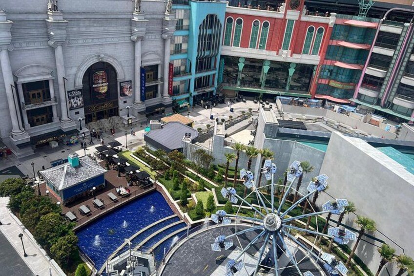 A Ferris wheel, a pool, and a historic building. 2