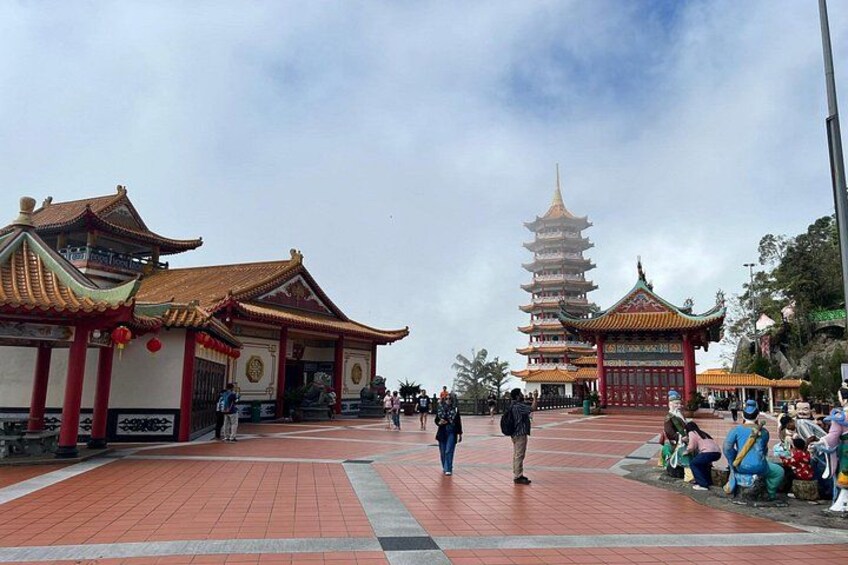 A traditional Chinese temple complex with pagodas and red-tiled walkways. 3