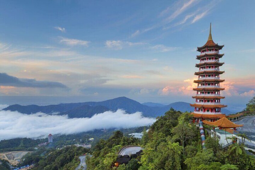 A pagoda with multiple tiers, surrounded by lush greenery and mountains in the background. 1