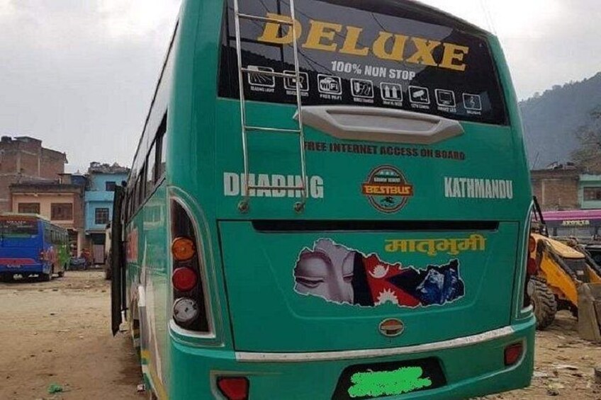 A green bus with 'DELUXE' and '100% NON STOP' text, and 'FREE INTERNET ACCESS ON BOARD' stickers. 3