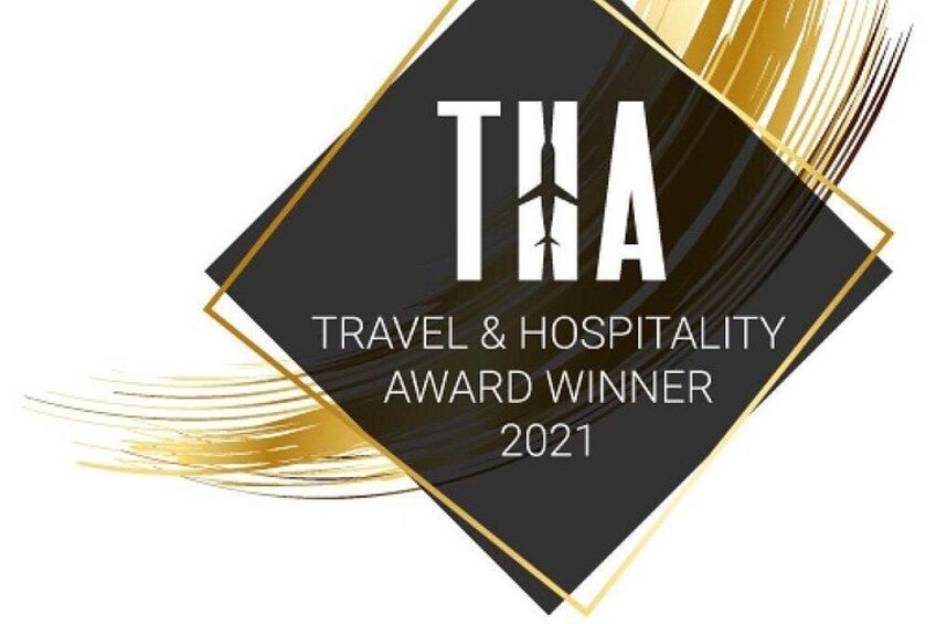A black and gold award plaque with the text 'THA TRAVEL & HOSPITALITY AWARD WINNER 2021'. 2