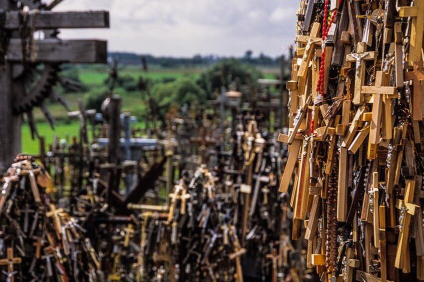 A collection of wooden tools and machinery, likely used for agricultural purposes, in a rural setting. 2