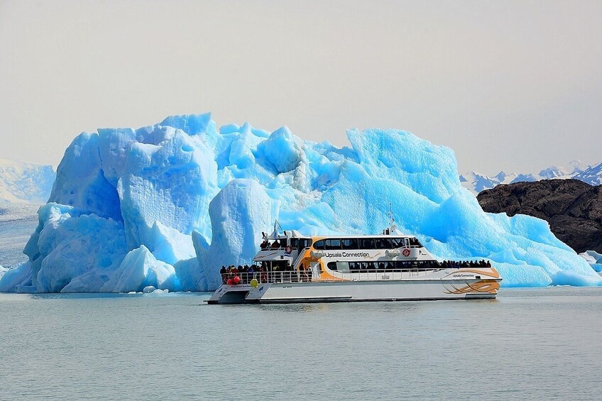A tour boat named Uppsala Connection near a large iceberg. 5