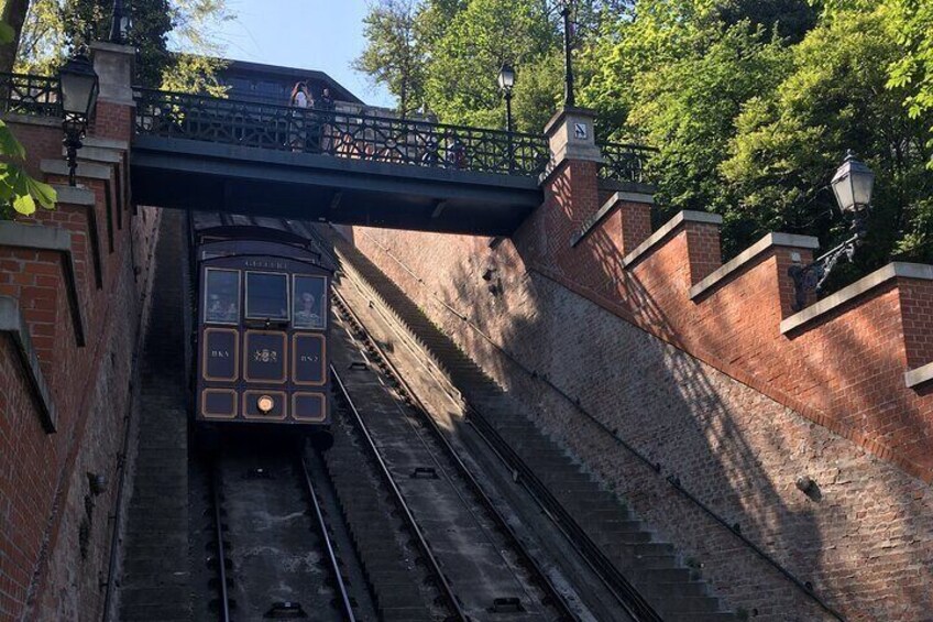 Een oudere trein onder een viaduct, spoorwegen, bakstenen muren en begroeiing. 4