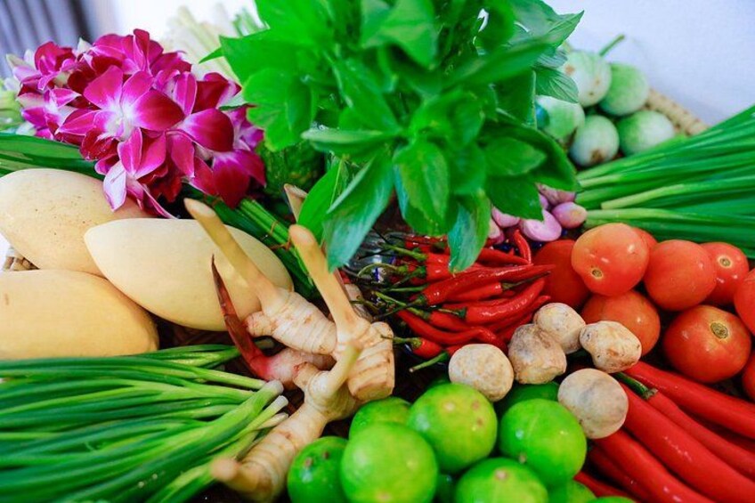 A variety of fresh vegetables and herbs, including tomatoes, green onions, and ginger. 2
