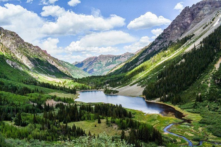 A mountainous landscape with a lake, dense forests, and a winding river. 3