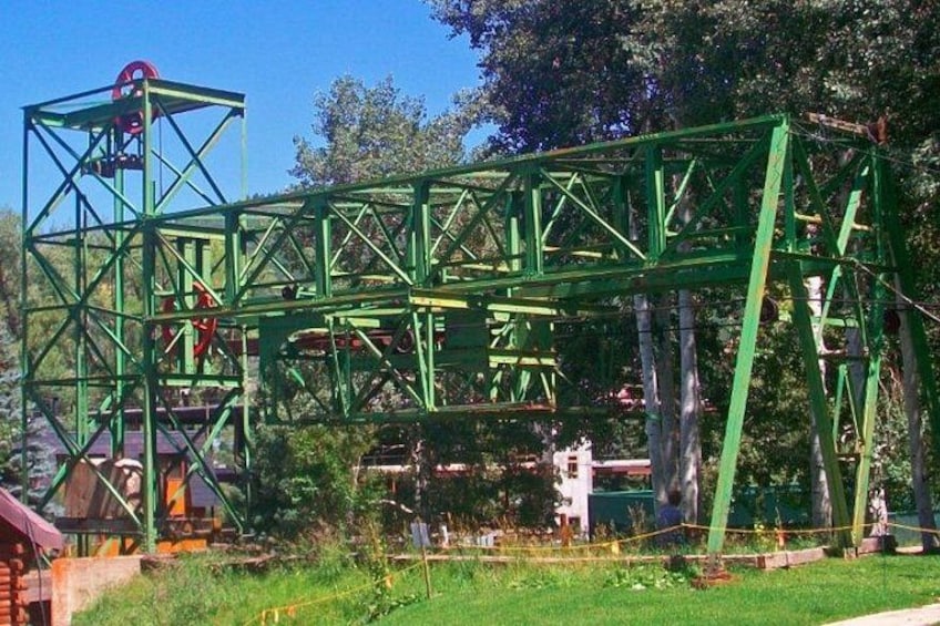 A large green metal structure, possibly a bridge or part of a park. 4